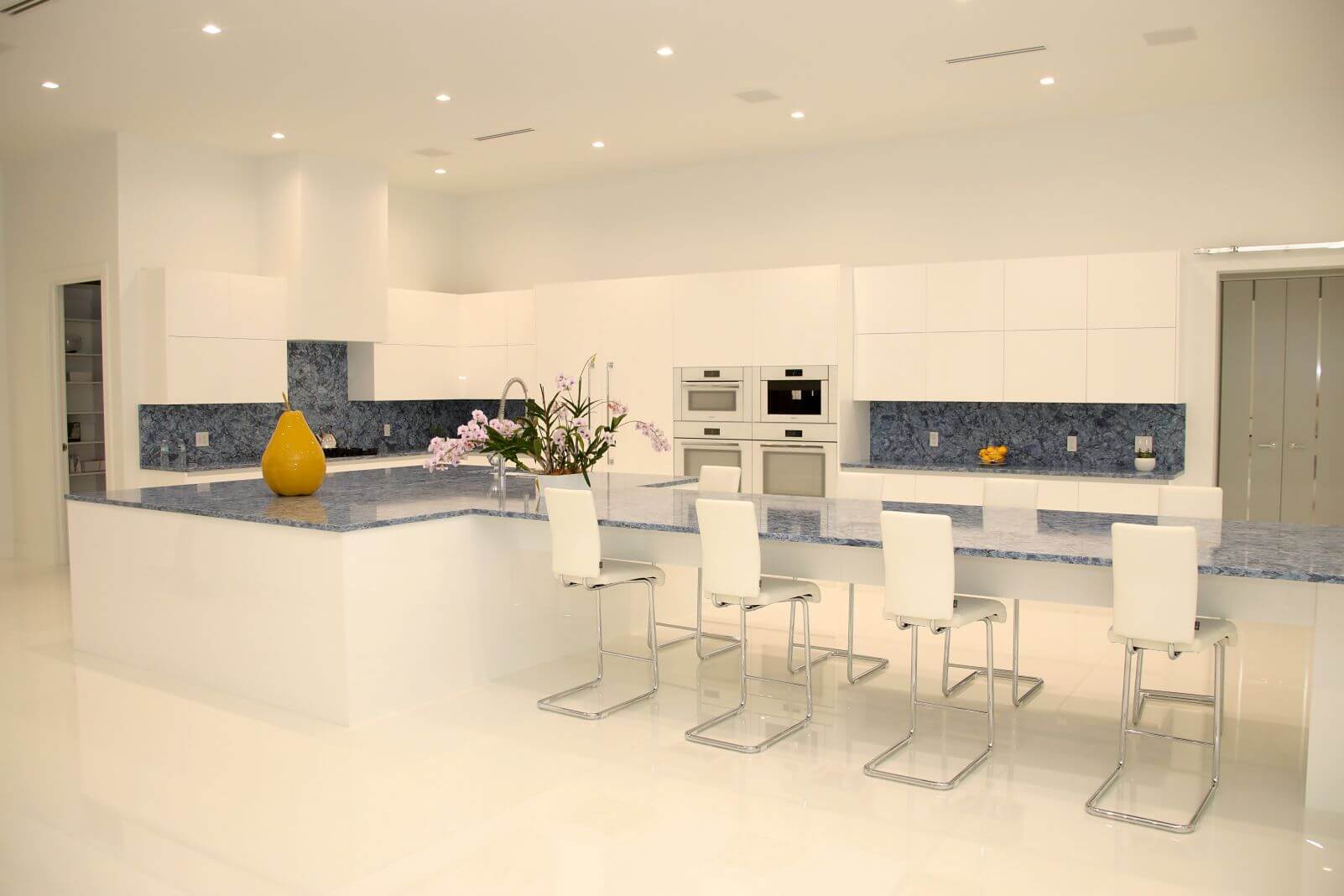 Luxury gourmet kitchen with custom cabinetry, oversized quartzite island, and premium appliances at Canvas Sur in Windermere, Florida.